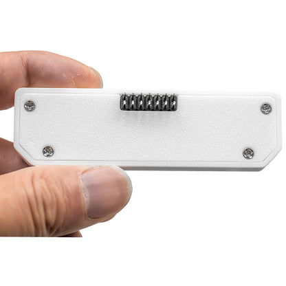 Hand holding the white Hydra case showing the 8-pin pogo connector on the underside