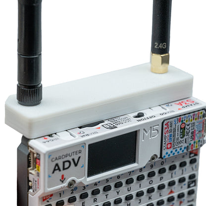 Angled close-up of the white Hydra case on Cardputer ADV with 2.4G stub